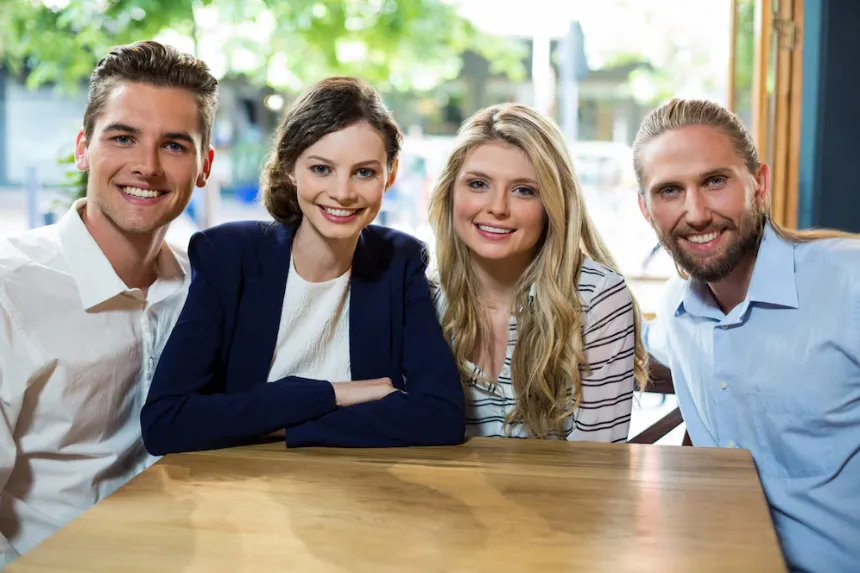 Smiling professionals sit together planning success, reminding readers that our business directory links people to helpful local businesses